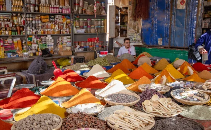 Colorful spices and goods displayed at a Moroccan market stall
