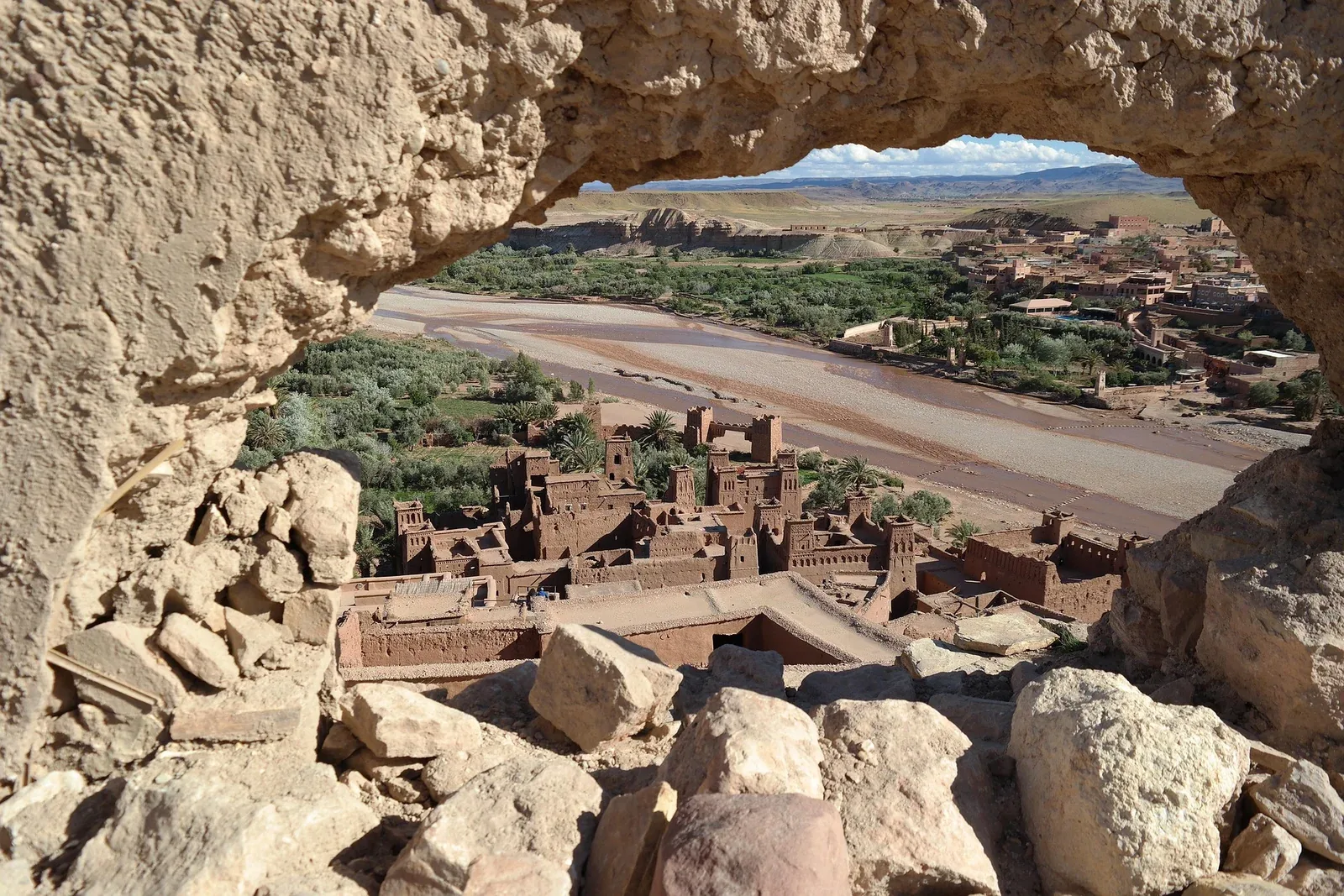 Ait Ben Haddou kasbah in southern Morocco, seen through a rock opening